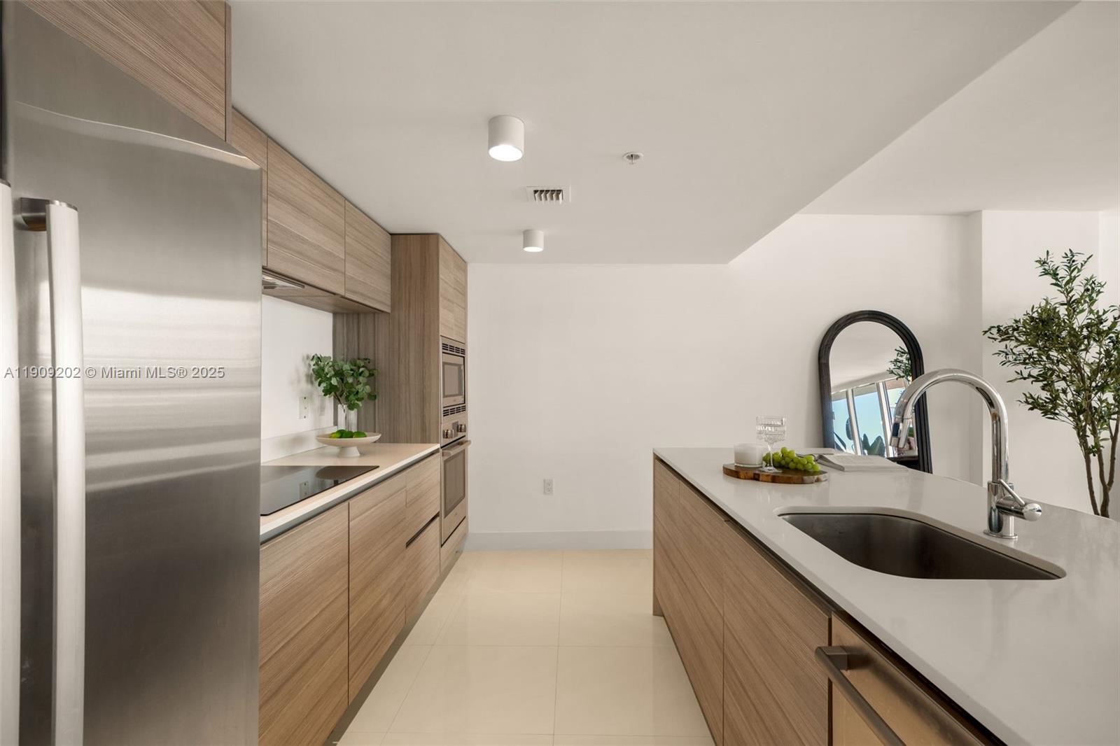 6620 Indian Creek Drive, Unit 713 Miami Beach, FL 33141 - Photo 7 of 39 a kitchen with stainless steel appliances granite countertop a sink a refrigerator and a stove