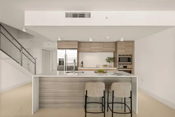 a kitchen with stainless steel appliances granite countertop a sink and cabinets