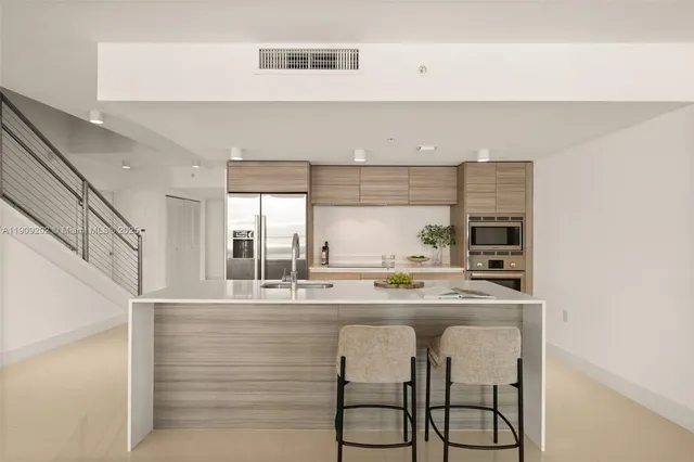 a kitchen with stainless steel appliances granite countertop a sink and cabinets