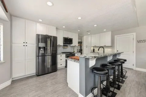 a kitchen with a refrigerator a sink and a stove