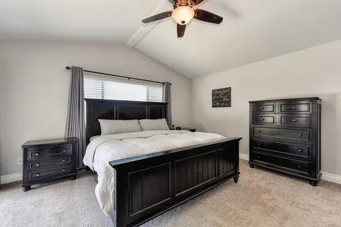 a bedroom with a bed and a dresser