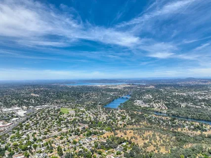 an aerial view of residential houses with city view