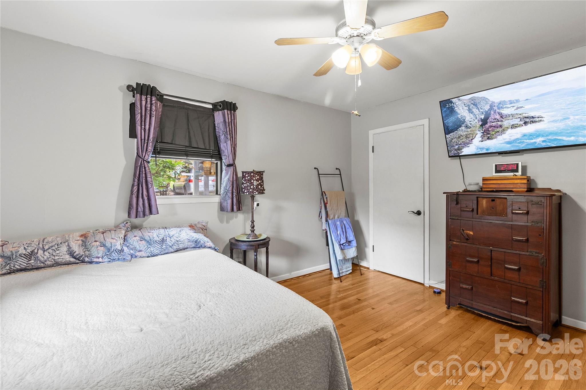 325 Swanson Road Lenoir, NC 28645 - Photo 25 of 35 a bedroom with a bed and a chandelier