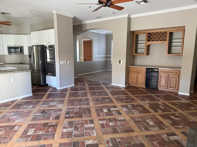 a view of a refrigerator in kitchen and a window