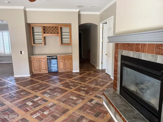 a living room with a fireplace and a rug