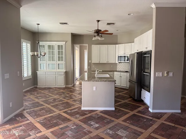 a view of a kitchen with granite countertop a stove top oven a sink and dishwasher