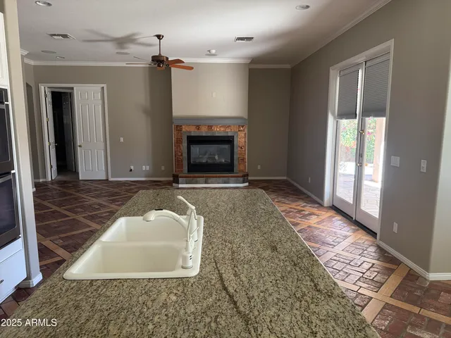 a kitchen with granite countertop white cabinets and stainless steel appliances