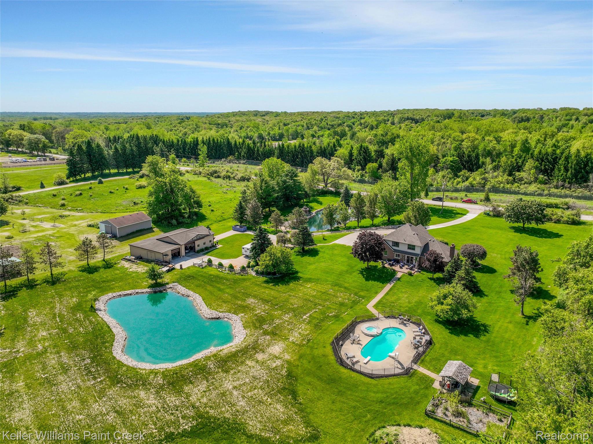 5813 36 Mile Road Romeo, MI 48065 - Photo 61 of 81 Expansive property featuring a large residence, separate outbuilding, private pond, in-ground swimming pool, and extensive green space