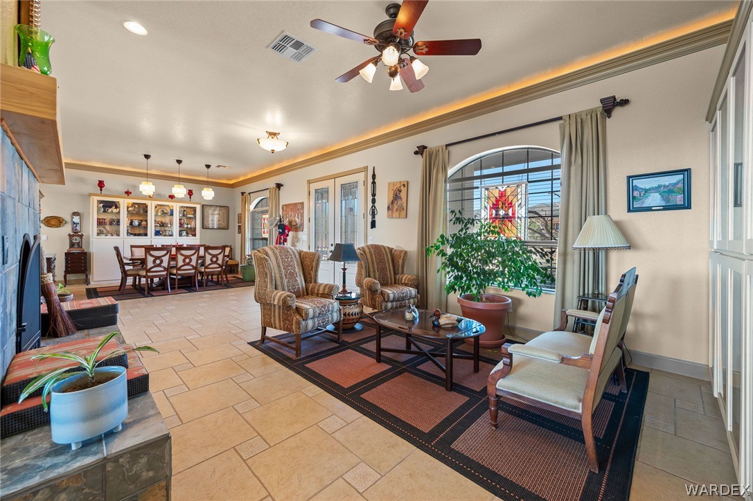 5840 North Cedar Ridge Lane Kingman, AZ 86409 - Photo 11 of 89 a living room with furniture gym equipment and a chandelier