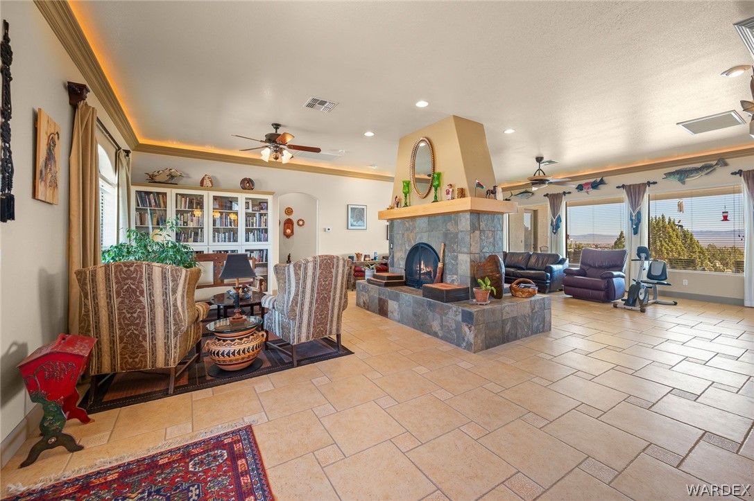 5840 North Cedar Ridge Lane Kingman, AZ 86409 - Photo 13 of 89 a living room with furniture a fireplace and a chandelier