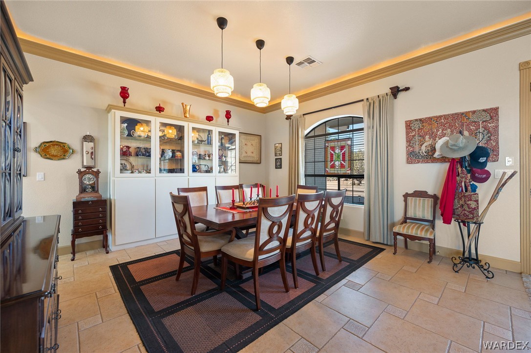 5840 North Cedar Ridge Lane Kingman, AZ 86409 - Photo 19 of 89 a view of a dining room with furniture and chandelier