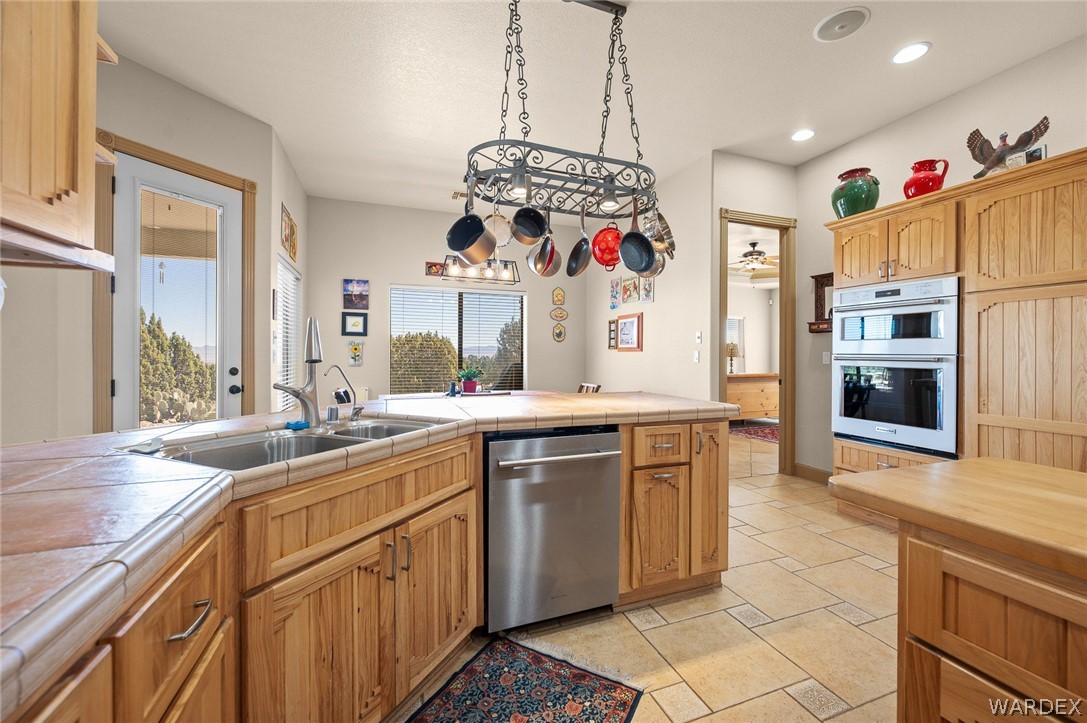5840 North Cedar Ridge Lane Kingman, AZ 86409 - Photo 25 of 89 a kitchen with stainless steel appliances granite countertop a sink and cabinets