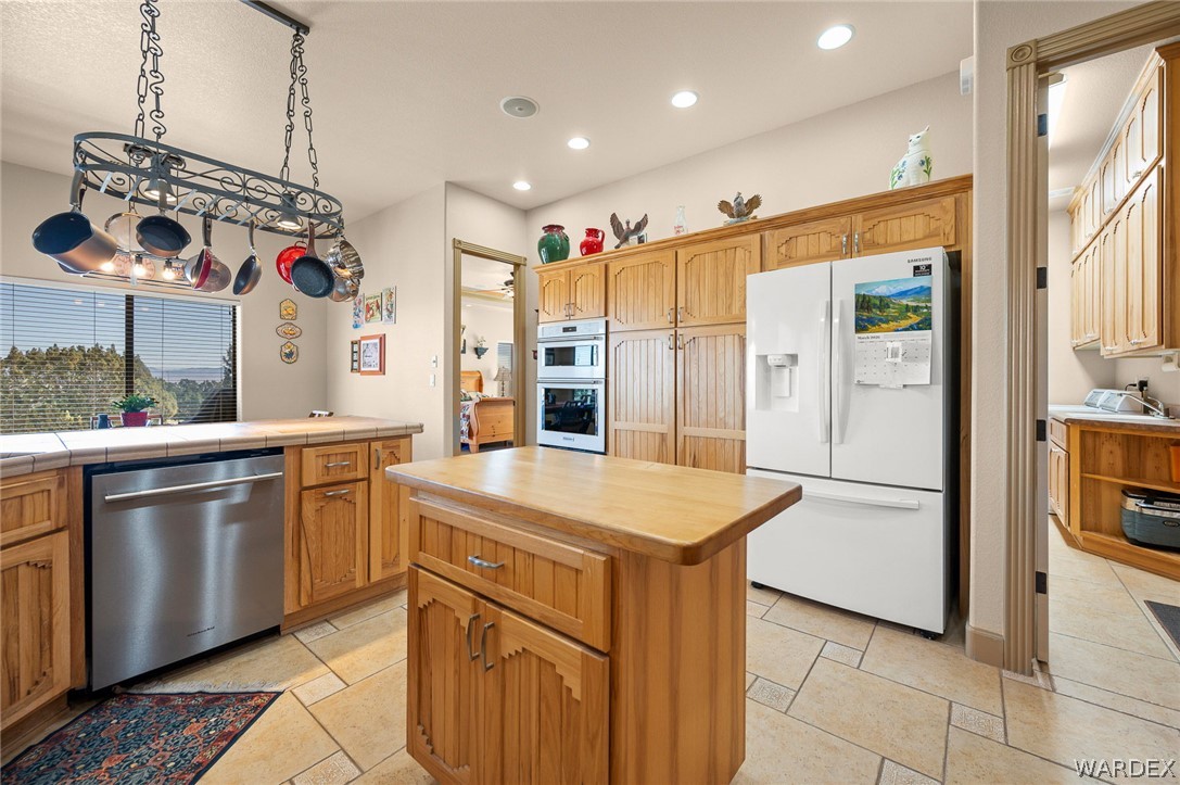5840 North Cedar Ridge Lane Kingman, AZ 86409 - Photo 26 of 89 a kitchen with stainless steel appliances granite countertop a refrigerator a oven and white cabinets with granite countertops