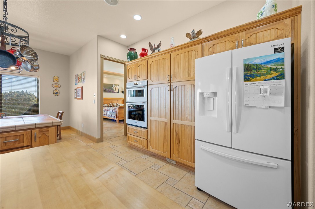 5840 North Cedar Ridge Lane Kingman, AZ 86409 - Photo 28 of 89 a kitchen with stainless steel appliances a refrigerator and a stove top oven