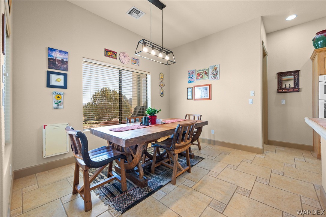 5840 North Cedar Ridge Lane Kingman, AZ 86409 - Photo 30 of 89 a view of a dining room with furniture and a chandelier