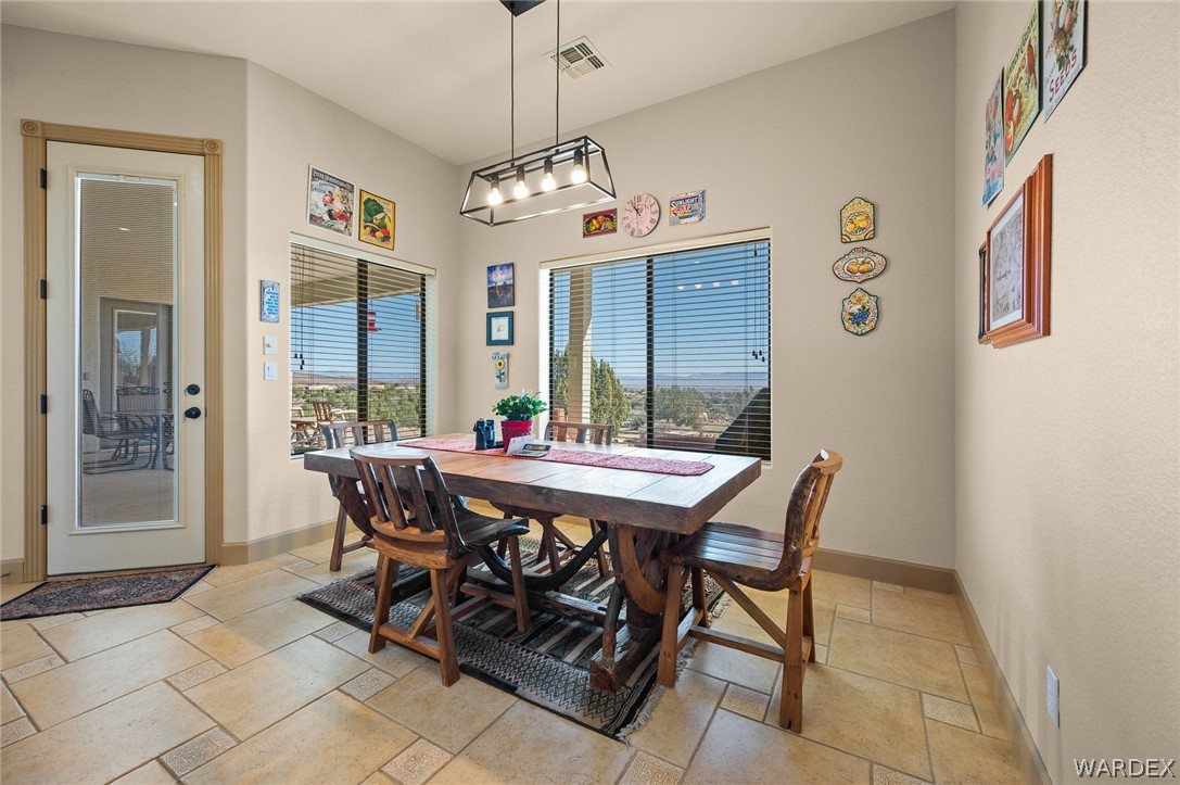 5840 North Cedar Ridge Lane Kingman, AZ 86409 - Photo 31 of 89 a view of a dining room with furniture and a chandelier