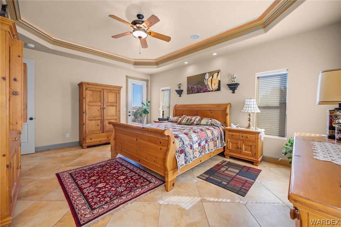 5840 North Cedar Ridge Lane Kingman, AZ 86409 - Photo 33 of 89 a bedroom with a bed a dresser and painting on the wall
