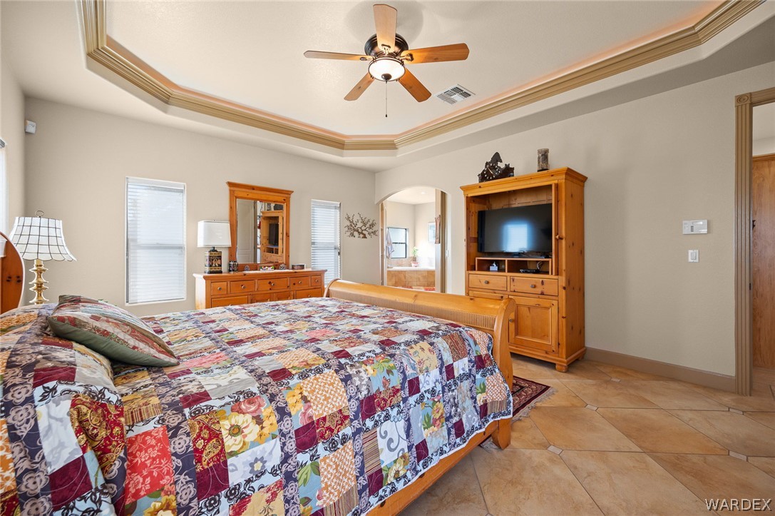 5840 North Cedar Ridge Lane Kingman, AZ 86409 - Photo 34 of 89 a bedroom with a bed and a flat screen tv