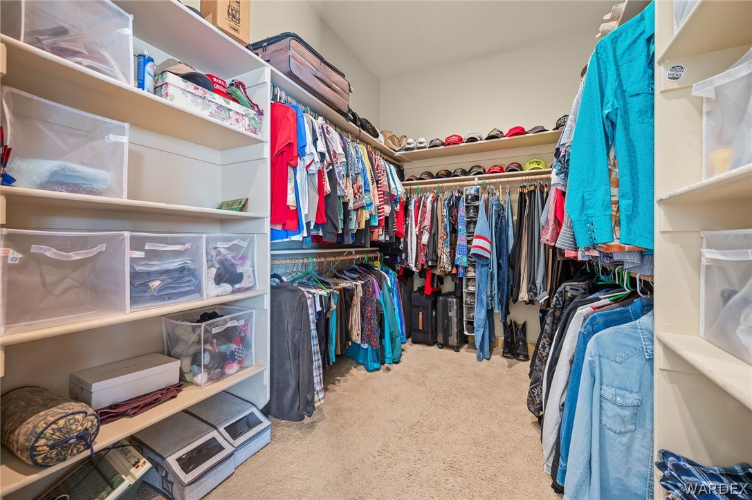 5840 North Cedar Ridge Lane Kingman, AZ 86409 - Photo 44 of 89 a view of walk in closet with clothes