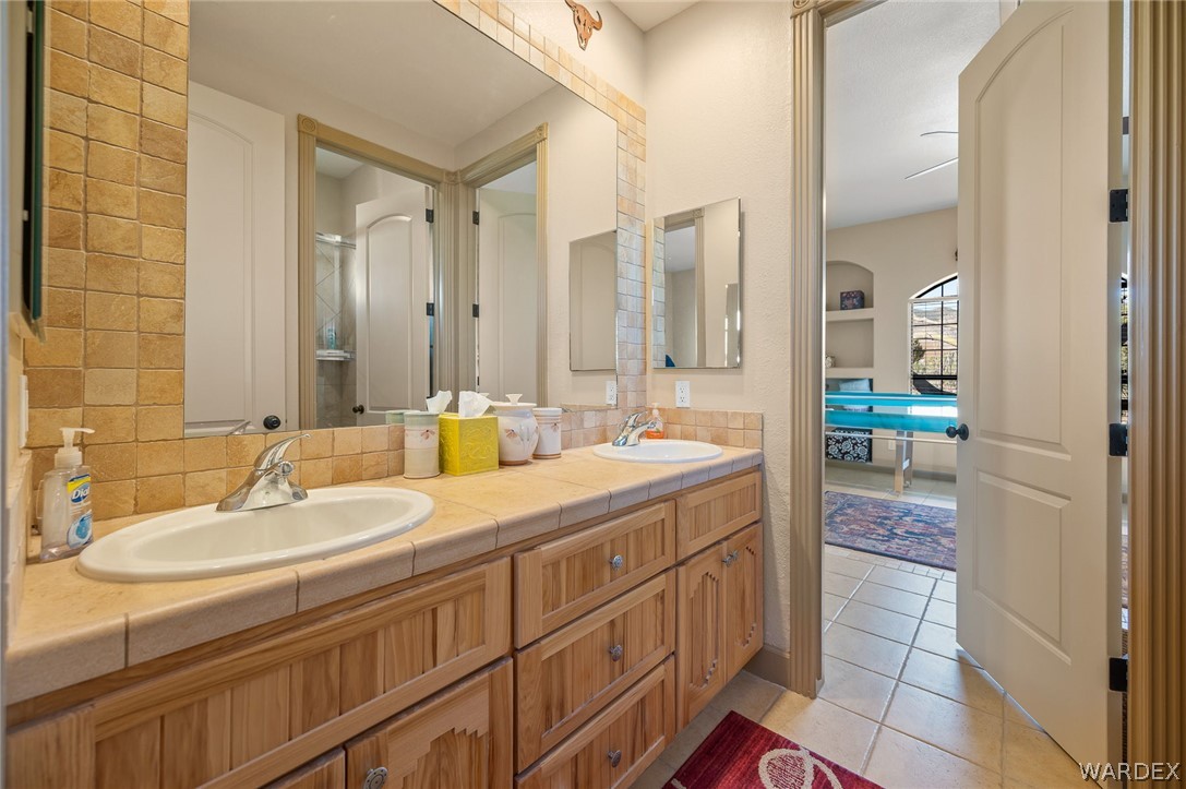 5840 North Cedar Ridge Lane Kingman, AZ 86409 - Photo 47 of 89 a bathroom with a sink double vanity and a mirror