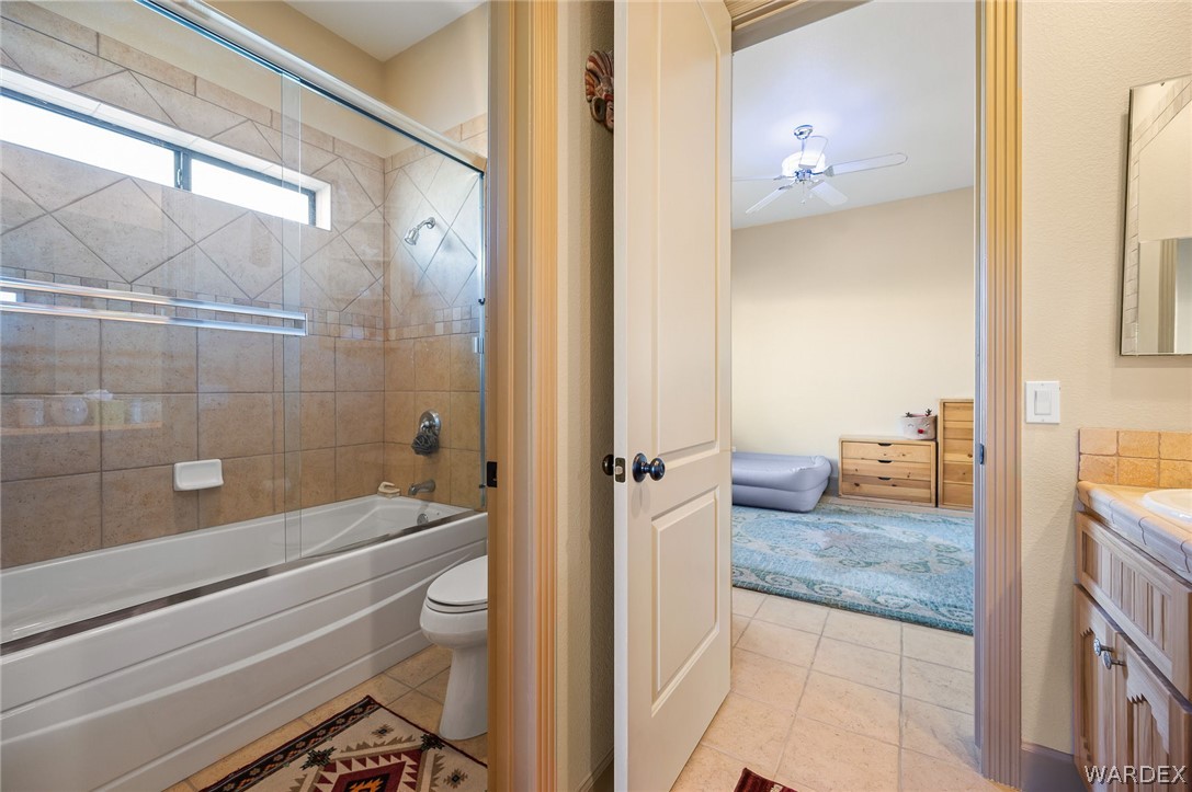 5840 North Cedar Ridge Lane Kingman, AZ 86409 - Photo 48 of 89 a bathroom with a granite countertop bathtub shower and toilet