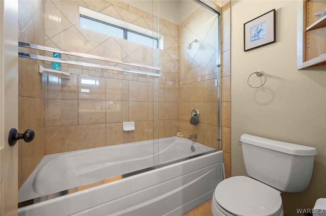 5840 North Cedar Ridge Lane Kingman, AZ 86409 - Photo 49 of 89 a white bath tub sitting next to a white toilet