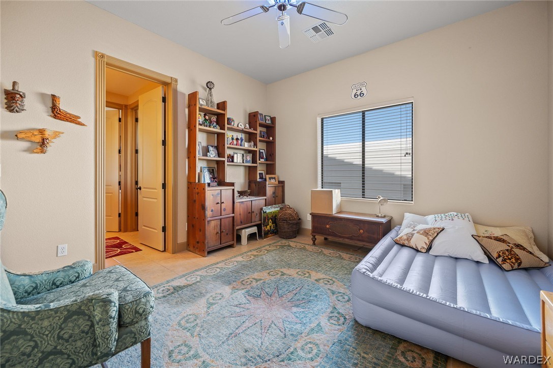 5840 North Cedar Ridge Lane Kingman, AZ 86409 - Photo 52 of 89 a living room with furniture and two windows