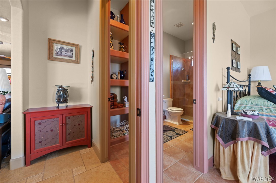 5840 North Cedar Ridge Lane Kingman, AZ 86409 - Photo 53 of 89 Entry to 2nd Primary with bathroom entrance form hallway and bedroom