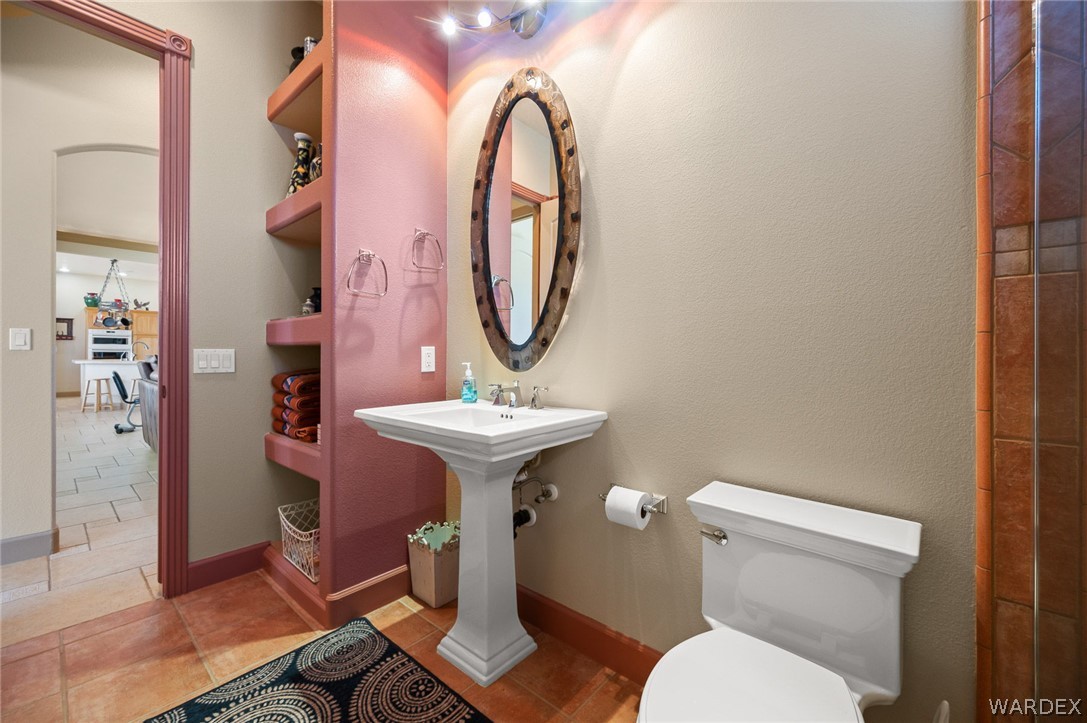5840 North Cedar Ridge Lane Kingman, AZ 86409 - Photo 54 of 89 a bathroom with a toilet sink and mirror