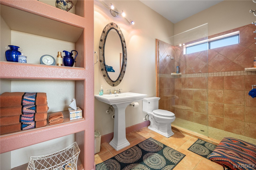 5840 North Cedar Ridge Lane Kingman, AZ 86409 - Photo 55 of 89 a bathroom with a toilet a sink and mirror