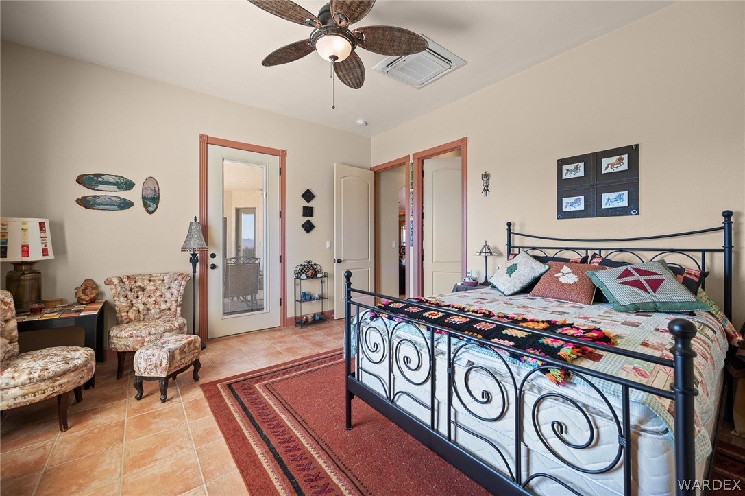 5840 North Cedar Ridge Lane Kingman, AZ 86409 - Photo 58 of 89 a bedroom with furniture and a chandelier