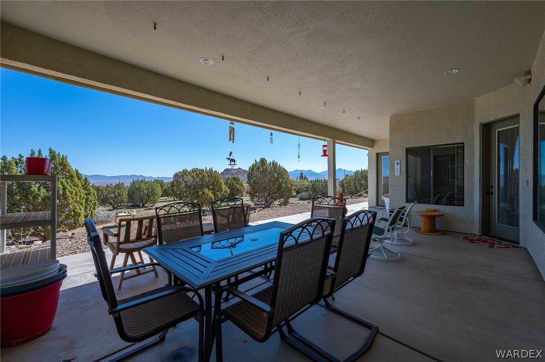 5840 North Cedar Ridge Lane Kingman, AZ 86409 - Photo 72 of 89 a view of a patio with a dining table and chairs