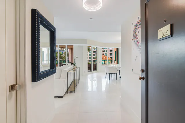 a kitchen with white cabinets and chairs