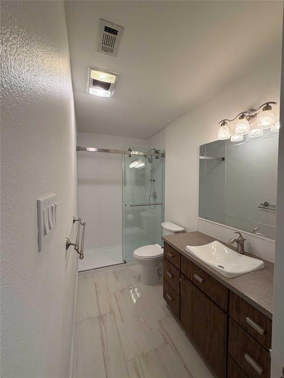 5020 Timber Creek Road Flower Mound, TX 75028 - Photo 11 of 15 a bathroom with a double vanity sink toilet and shower