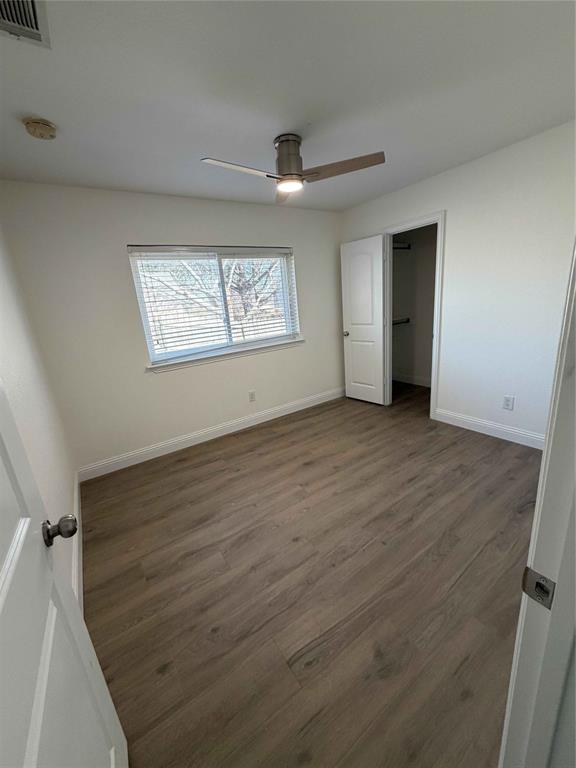5020 Timber Creek Road Flower Mound, TX 75028 - Photo 13 of 15 an empty room with wooden floor and windows