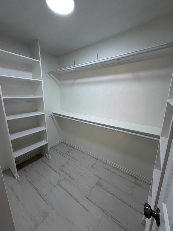 5020 Timber Creek Road Flower Mound, TX 75028 - Photo 10 of 15 a view of walk in closet with empty racks