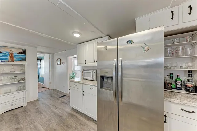 a view of a hallway with dining room and wooden floor