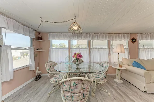 a view of a dining room with furniture and a chandelier
