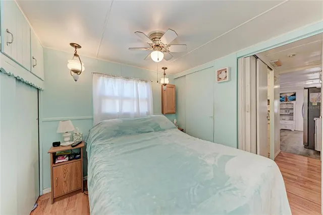 a bedroom with a large bed and a large window