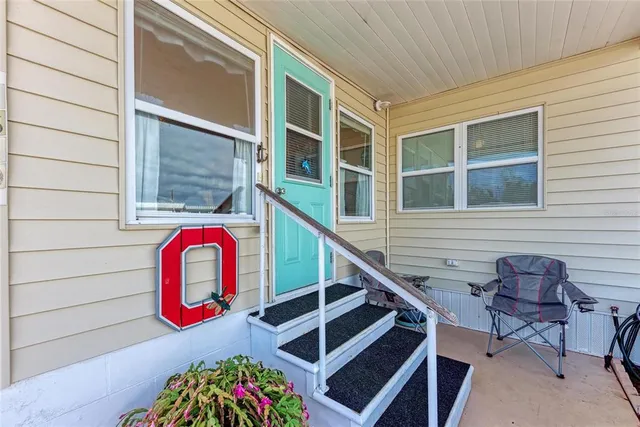 a couple of chairs sitting in front of a house