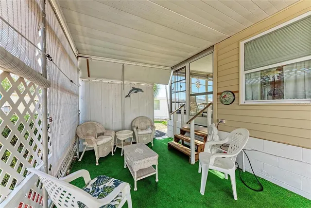 a balcony with table and chairs