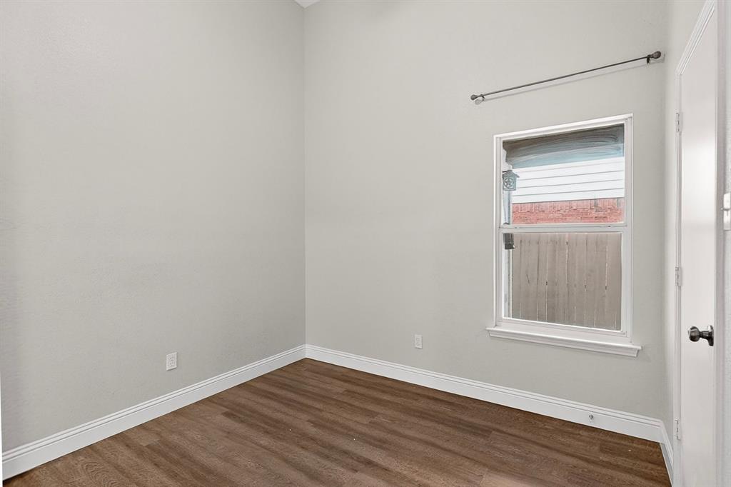 7729 Misty Ridge Drive North Fort Worth, TX 76137 - Photo 19 of 30 a view of an empty room with wooden floor and a window