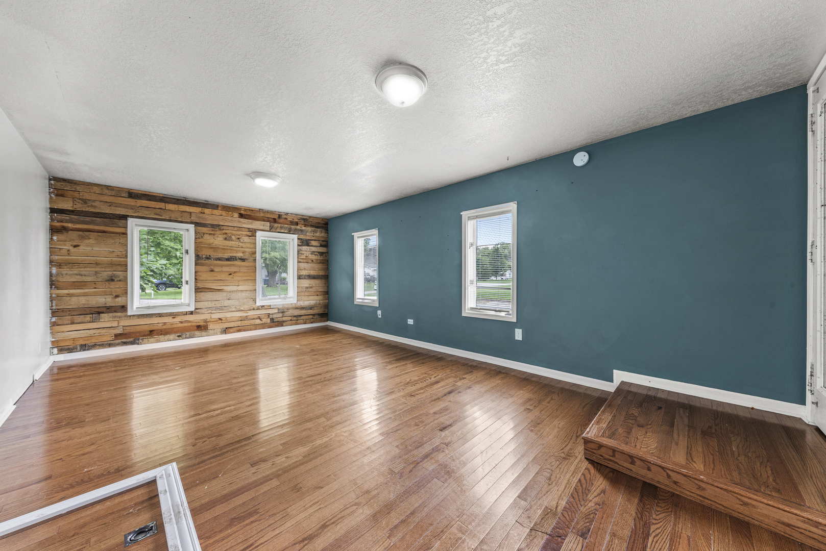 2 Baker Street Kankakee, IL 60901 - Photo 12 of 17 an empty room with wooden floor and windows