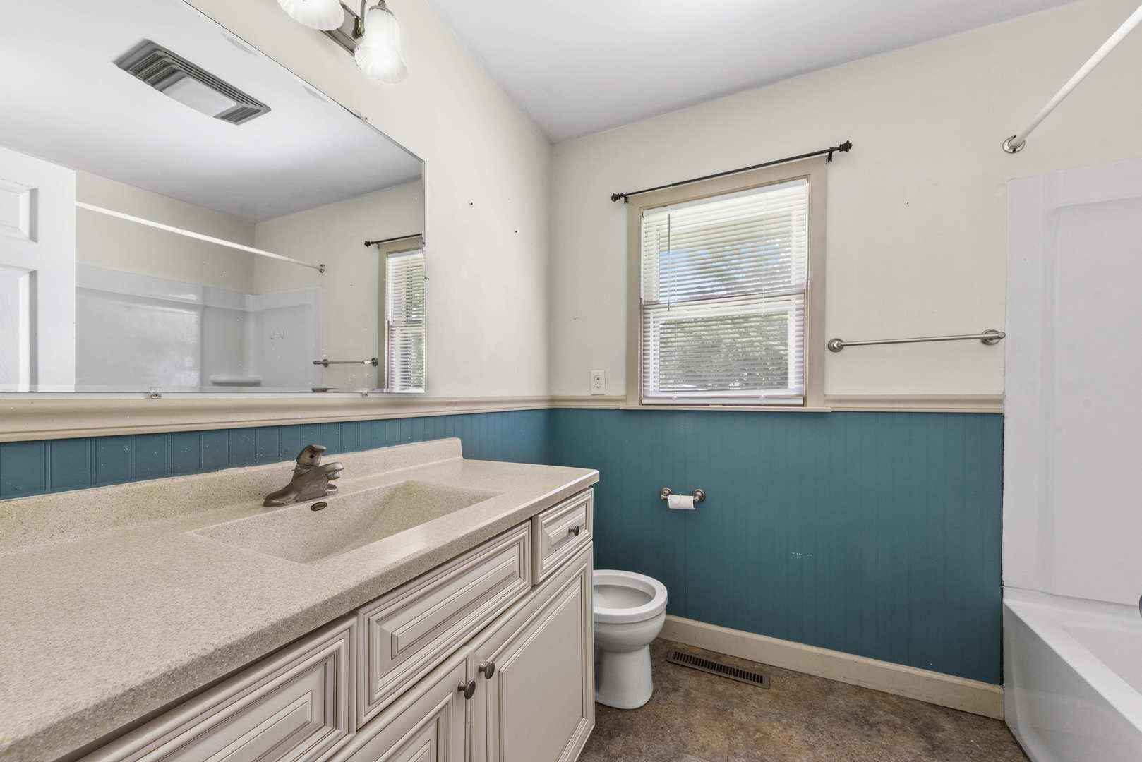 2 Baker Street Kankakee, IL 60901 - Photo 13 of 17 a bathroom with a sink a toilet and mirror