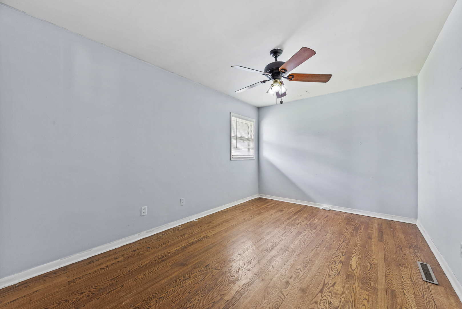 2 Baker Street Kankakee, IL 60901 - Photo 14 of 17 a view of an empty room with window and wooden floor