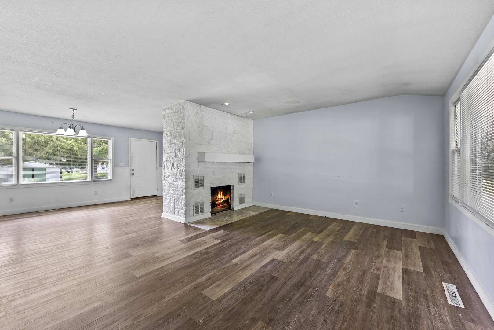 2 Baker Street Kankakee, IL 60901 - Photo 4 of 17 wooden floor in an empty room with a fireplace