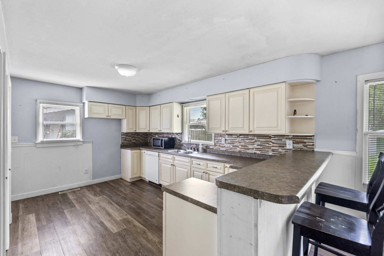 2 Baker Street Kankakee, IL 60901 - Photo 9 of 17 a kitchen with a stove a sink and a refrigerator