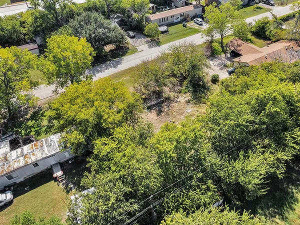 an aerial view of residential houses with yard