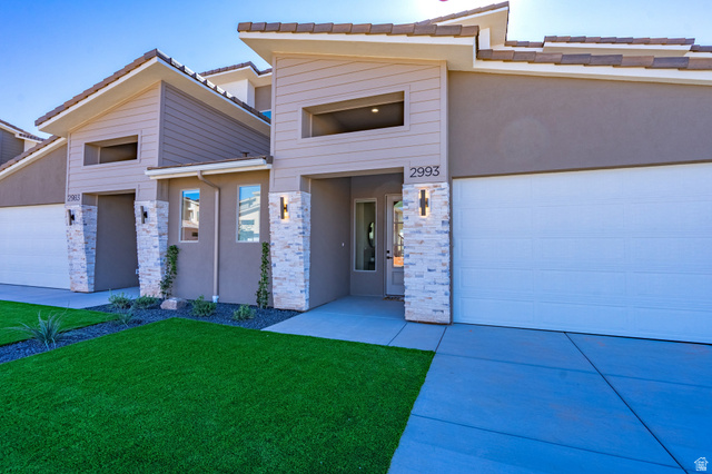 2972 West 570 North Hurricane, UT 84737 - Photo 8 of 104 View of front of house with a front yard, stucco siding, and stone siding