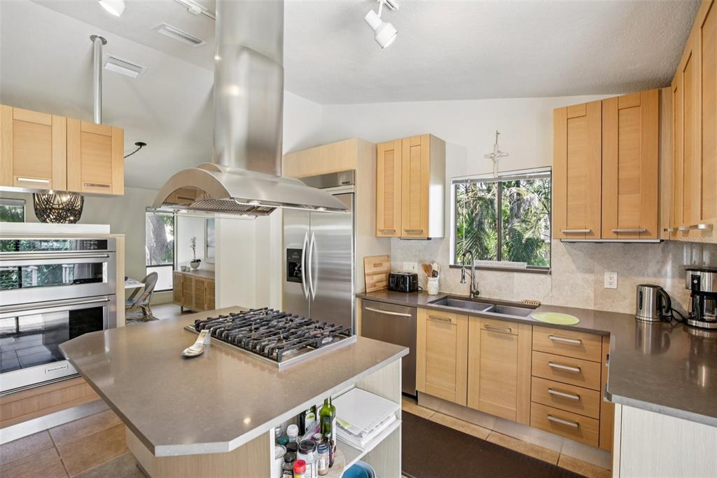 3390 Bayou Sound Longboat Key, FL 34228 - Photo 5 of 59 a kitchen with stainless steel appliances a stove a sink and white cabinets
